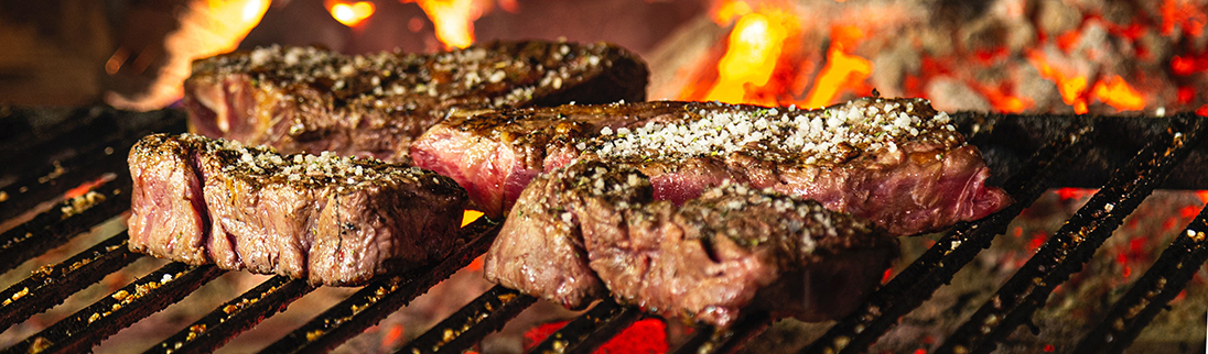 A steak cooks on a hot grill. Photo credit: Gonzalo Guzman.